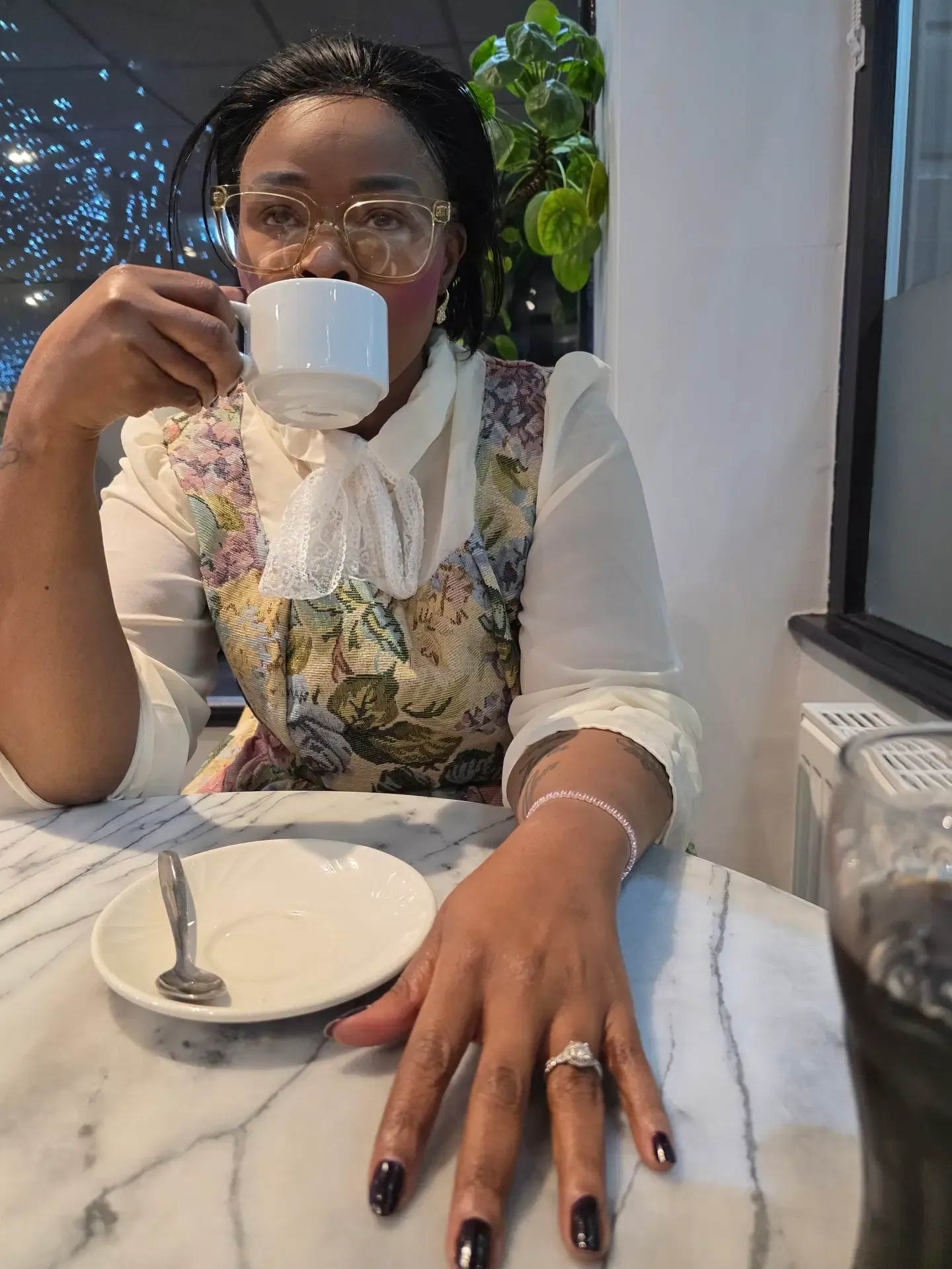Akhona enjoying a coffee at a cafe